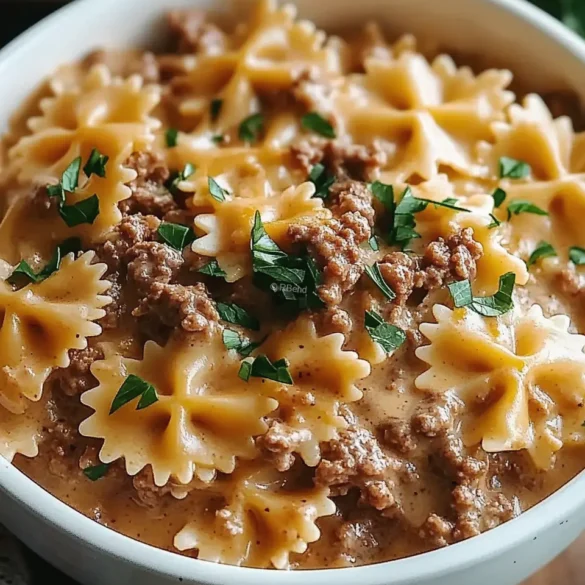 Creamy Beef and Bowtie Pasta Creamy bowtie pasta with ground beef and cheddar cheese in a white bowl