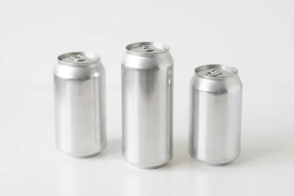 Row of three unbranded iced tea cans representing Twisted Tea Original, Light and Half and Half varieties